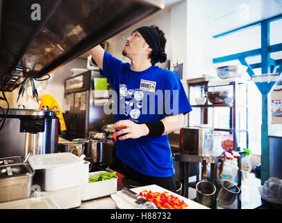 The ramen noodle shop. Staff in a small kitchen preparing food Stock Photo
