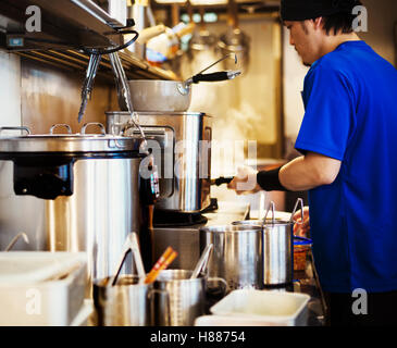 The ramen noodle shop. A chef working in a kitchen. Stock Photo