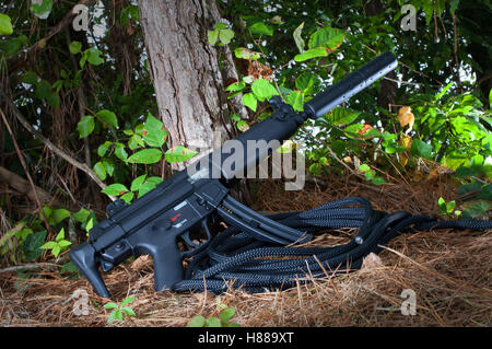 Black and short rifle that has a silencer on the end Stock Photo