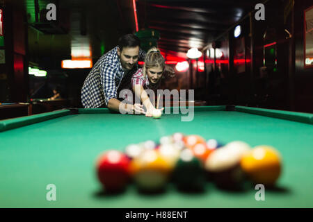 Couple dating and having fun playing snooker Stock Photo