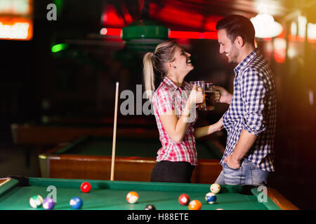 Couple dating and having fun playing snooker Stock Photo