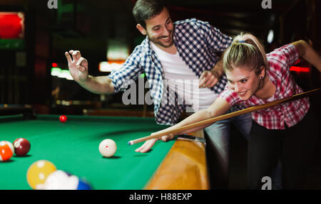 Couple playing snooker together Stock Photo