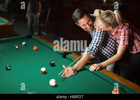 Couple playing snooker together Stock Photo