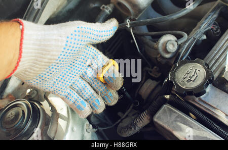 The oil dipstick of the car in a hand Stock Photo