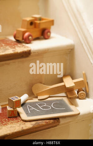 old wooden toys on stairs Stock Photo