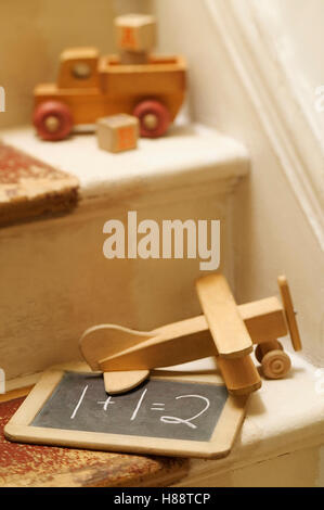 old wooden toys on stairs Stock Photo