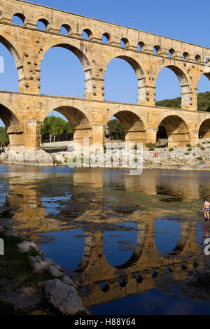People near the famous landmark ancient old double arches of Roman aqueduct of Pont du Gard, Nimes Stock Photo