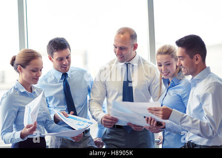 happy business people with papers talkig in office Stock Photo