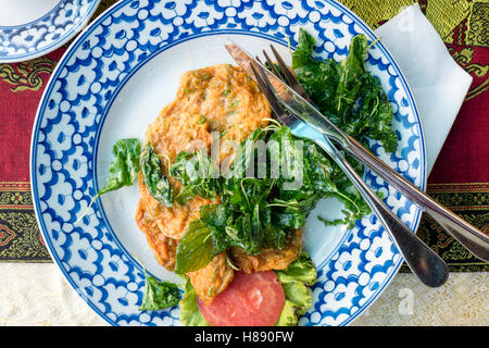 Traditional Thai fish cakes served with Thai basil Stock Photo