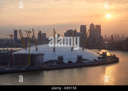 The O2 Arena and Canary Wharf district seen across the Thames at sunset, London England United Kingdom UK