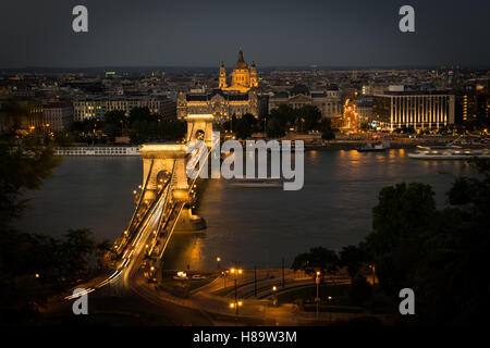 Széchenyi Chain Bridge, Four Seasons Hotel Gresham Palace and St. Stephen's Basilica the darkest Stock Photo