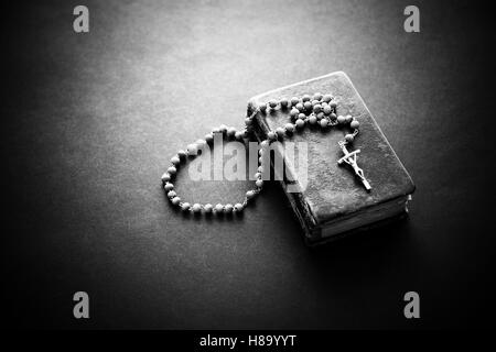 Rosary on the old Bible Stock Photo