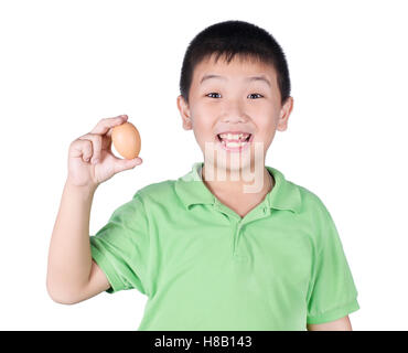 Boy holding hen egg in hand on white background isolated Stock Photo