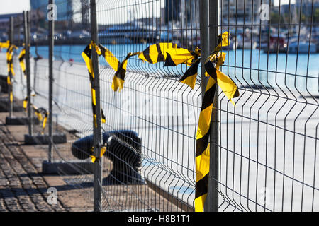 fence with ribbons on a construction site Stock Photo