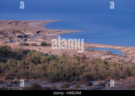 View of sinkholes also known as dolines or cenotes formed by dissolution of underground salt by incoming freshwater, as a result of a continuing sea level drop at the Dead Sea coast in Israel Stock Photo