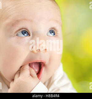 adorable happy baby on natural green blurred background with nice circle bokeh Stock Photo