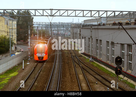 SAINT-PETERSBURG, RUSSIA - September 27, 2016: modern locomotive pulling a high-speed electric train Lastochka (Swallow) on rail Stock Photo