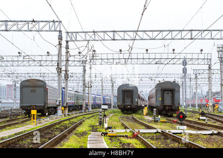 Old locomotives and  railcars rzd stand on railroad tracks of technical railway station operational locomotive depot. Transport Stock Photo