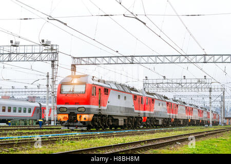 Old locomotiv and railcars rzd stand on railroad tracks of technical railway depot. Transport infrastructure of Russian railways Stock Photo