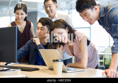 Chinese business people working together with computer and laptop Stock Photo