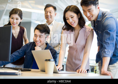 Chinese business people working together with computer and laptop Stock Photo