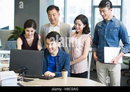 Chinese business people working together with computer Stock Photo