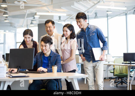 Chinese business people working together with computer Stock Photo