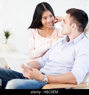 Smiling couple using a tablet together. Stock Photo
