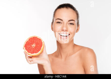 Beauty portrait of a happy woman holding grapefruit isolated on a white background Stock Photo