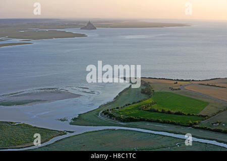 Mont Saint-Michel (Saint Michael's Mount), (Normandy, north-western France): aerial view over the bay during a spring tide with the Grouin du sud headland at the bottom, on the right. Stock Photo