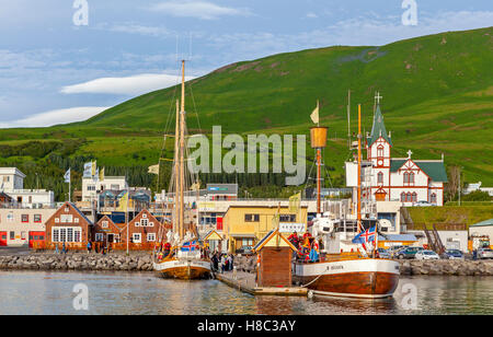 A view of fishing and tourist boats in the Husavik bay in Iceland. Stock Photo