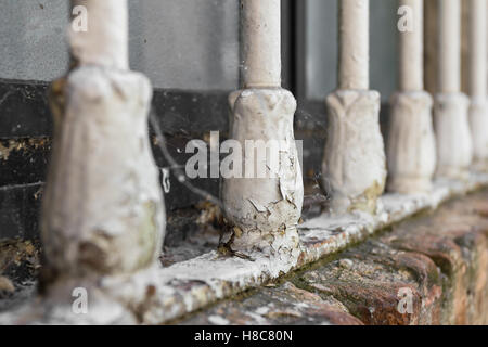Closeup of old window bars with peeling paint, dirt and cobwebs. Stock Photo