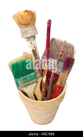 Tools of the rural painter - dirty brushes and sticks for stirring of paints. Isolated Stock Photo