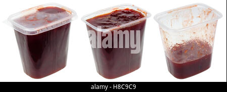 Transparent plastic storage containers of food are filled with plum jam. Set of fill in closed, opened and half empty boxes. Iso Stock Photo