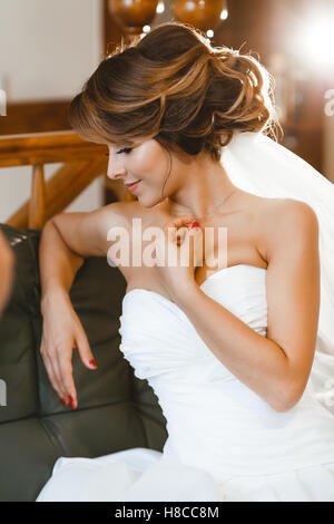 Bride sitting on sofa Stock Photo
