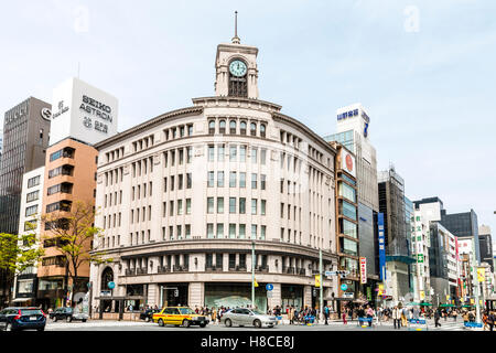 Japan, Tokyo, Ginza. Famous landmark, the corner Wako Department store building with its iconic roof clock tower, seen from across street. Daytime. Stock Photo