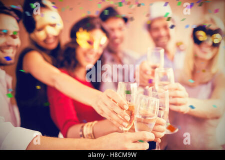 Composite image of cropped image of hands holding champagne flute Stock Photo
