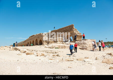 CAESAREA, ISRAEL - APRIL 2, 2016: people exploring ancient Roman aqueduct on a sea coast in Maritima National Park in Caesarea, Stock Photo