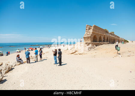 CAESAREA, ISRAEL - APRIL 2, 2016: people exploring ancient Roman aqueduct on a sea coast in Maritima National Park in Caesarea, Stock Photo