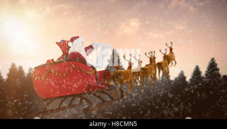 Composite image of santa claus riding on sled during christmas Stock Photo