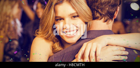 Composite image of happy couple hugging each other Stock Photo