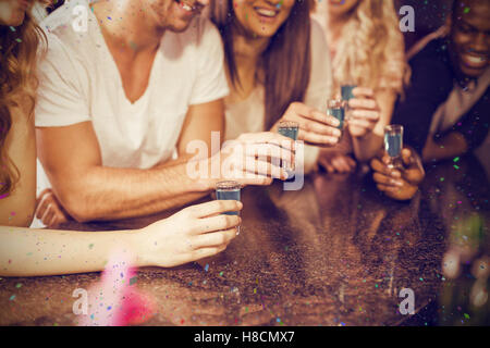 Composite image of cropped image of hands having shots Stock Photo