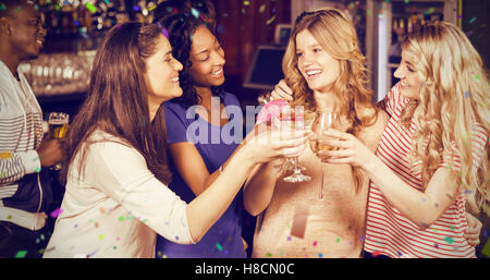 Composite image of friends drinking cocktails together Stock Photo