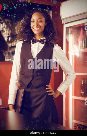 Composite image of portrait of bartender standing with menu card Stock Photo