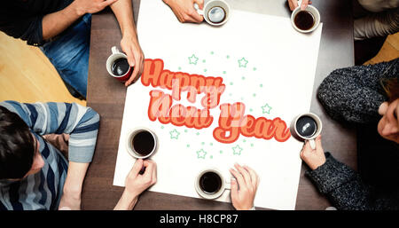 People sitting around table drinking coffee against new year graphic Stock Photo