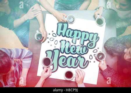 People drinking coffee around new year message Stock Photo