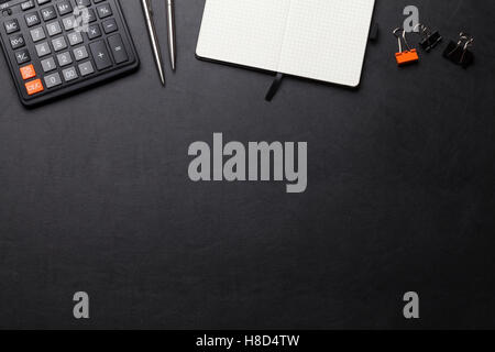 Office leather desk table with calculator, notepad, pen and pencil. Top view with copy space Stock Photo