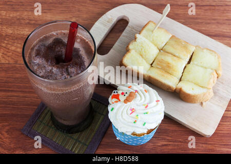 Cocoa chocolate smoothie in glass and Buttered bread and cup cake Stock Photo