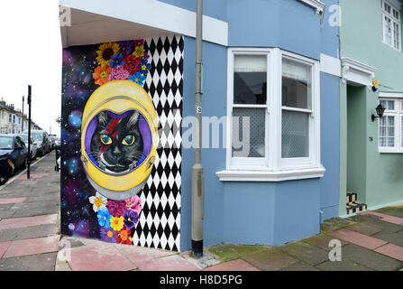 Corner house with a quirky cat mural painted on end wall in Hanover district of Brighton UK Stock Photo