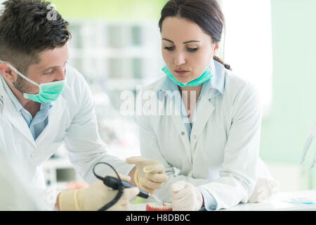 Dental students while working on the denture, false teeth. Stock Photo